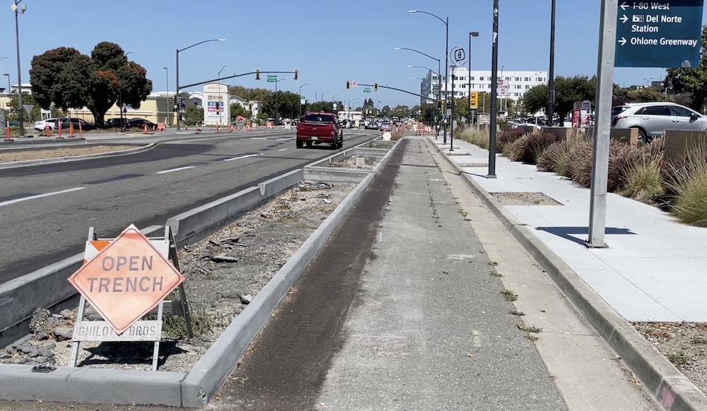 photo of San Pablo Ave protected bikeway curbs under construction near Del Norte BART in El Cerrito