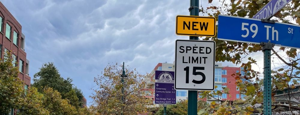 photo of a new 15 mph speed limit sign next to a bicycle boulevard wayfinding sign at Horton St and 59th St in emeryville
