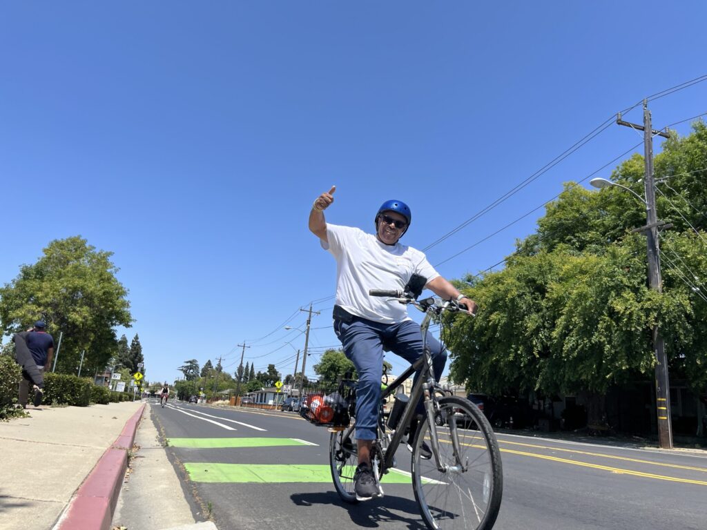 Happy man riding in bike lane